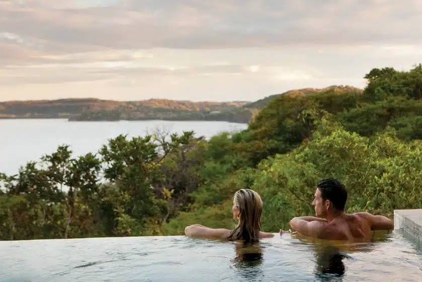 Couple enjoying a Costa Rica beach sunset on honeymoon